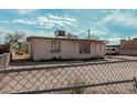 Fenced backyard of a modest home with a view of the exterior at 1813 W Tamarisk St, Phoenix, AZ 85041