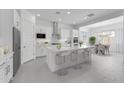Bright, modern kitchen with white cabinets, stainless steel appliances, and an island with seating at 19094 E Broadmoor Trl, Queen Creek, AZ 85142