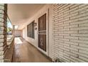 Inviting front porch featuring brick accents, a security door, and ample natural light at 20006 N Concho Cir, Sun City, AZ 85373