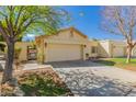 Inviting exterior view showcasing a two-car garage and a cozy, well-maintained front yard at 21 W Ranch Rd, Tempe, AZ 85284