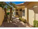 A quaint courtyard entrance featuring a private outdoor seating area, lush greenery, and a welcoming front door at 21 W Ranch Rd, Tempe, AZ 85284