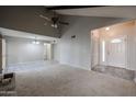 Open-concept living room with large windows, neutral walls, and tile flooring leading to the entry at 2113 N Squire Ave, Tempe, AZ 85288