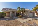 Inviting single-story home with desert landscaping and a walkway leading to the front entrance at 22120 N Old Mine Rd, Sun City West, AZ 85375