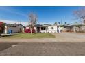 Charming single-story home with solar panels, lush landscaping, and ample parking space at 2302 E Sells Dr, Phoenix, AZ 85016