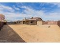 Expansive backyard with covered patio, storage sheds, and plenty of space for outdoor activities at 2643 E Jerome Ave, Mesa, AZ 85204