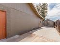 Side view of a home showing the exterior paint, backyard access, and a storage shed at 2643 E Jerome Ave, Mesa, AZ 85204