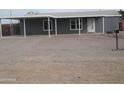 Single-story home with covered parking and gravel driveway at 329 N 83Rd Pl, Mesa, AZ 85207