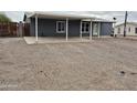 Single-story home with covered parking and a gravel driveway in a rural community at 329 N 83Rd Pl, Mesa, AZ 85207