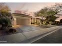 Desert home with a two-car garage and a beautiful desert landscaped yard at 33389 N 71St St, Scottsdale, AZ 85262