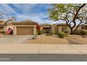 Well-maintained home with desert landscaping, two-car garage, and an American flag at 33389 N 71St St, Scottsdale, AZ 85262