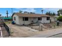 Attractive single-story home with a covered porch and a well-maintained front yard and driveway at 3527 W Almeria Rd, Phoenix, AZ 85009