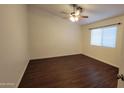 A simple bedroom featuring hardwood floors, a ceiling fan and a window with coverings at 4517 N 123Rd Dr, Avondale, AZ 85392