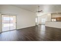 Bright living room with wood-look floors, sliding glass doors and a ceiling fan, creating an inviting space at 4517 N 123Rd Dr, Avondale, AZ 85392