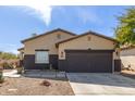 Charming single-story home with desert landscaping and a two-car garage at 45341 W Paraiso Ln, Maricopa, AZ 85139