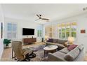 Light-filled living room with stylish furniture, TV and large windows at 4627 E Sourwood Dr, Gilbert, AZ 85298