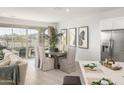 Bright dining area with a modern table, seating, and sliding glass door to the outdoor space at 4752 E Topaz Dr, San Tan Valley, AZ 85140