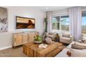 Comfortable living room featuring a wooden coffee table, chairs, and a decorative TV display at 4752 E Topaz Dr, San Tan Valley, AZ 85140