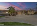 Stunning single-story home with an oversized driveway and desert landscaping at 4915 N Greentree Dr, Litchfield Park, AZ 85340