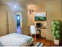 Cozy bedroom has natural light, a small desk, and bright artwork at 537 N Jay St, Chandler, AZ 85225