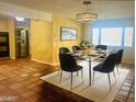 Bright dining room features a glass table, modern chandelier and a neutral rug at 537 N Jay St, Chandler, AZ 85225