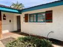 Front entrance featuring stucco walls, tile floor, and decorative shutters at 537 N Jay St, Chandler, AZ 85225