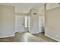 Bright entryway featuring neutral walls, tiled flooring, and a view of the front door at 5552 W Willow Ave, Glendale, AZ 85304