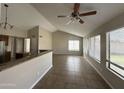 Spacious living room with vaulted ceiling, tile floor, and large window at 5552 W Willow Ave, Glendale, AZ 85304