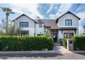 Charming two-story home featuring a well-manicured lawn, lush hedges, and modern farmhouse accents at 5601 E Monterosa St, Phoenix, AZ 85018