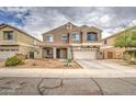 Attractive two-story house features low-water landscaping, a covered porch, and a convenient driveway at 7013 W Branham Ln, Laveen, AZ 85339