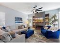 Comfortable living room showcasing a modern fireplace, built-in shelving, a ceiling fan, and stylish decor at 7161 W Saddlehorn Rd, Peoria, AZ 85383