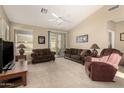 Comfortable living room with neutral carpet, ceiling fan, and sliding glass door at 9638 E Tranquility Way, Sun Lakes, AZ 85248