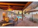 Relaxing covered patio with a ceiling fan, outdoor seating, and a view of the pool and backyard at 12837 S 41St St, Phoenix, AZ 85044