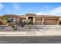 Attractive single-story home with three-car garage and manicured desert landscaping at 13018 S 177Th Ln, Goodyear, AZ 85338