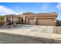 Well-maintained single-story home with a three-car garage and low-maintenance desert landscaping at 13018 S 177Th Ln, Goodyear, AZ 85338