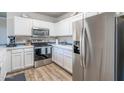 Bright kitchen with stainless steel appliances, white cabinets, and blue backsplash at 20100 N 78Th Pl # 2098, Scottsdale, AZ 85255