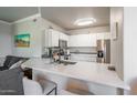 Modern kitchen featuring white cabinets, stainless steel appliances, and a breakfast bar at 20100 N 78Th Pl # 2098, Scottsdale, AZ 85255