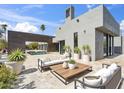 Modern outdoor patio with sleek furniture, potted plants, and view of the pool at 24201 N 87Th St, Scottsdale, AZ 85255
