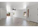 Bright living room with tile floors, leading to the backyard through sliding glass doors at 25073 W Dove Trl, Buckeye, AZ 85326