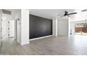 Spacious living area showcasing a striking accent wall and tile flooring throughout at 25073 W Dove Trl, Buckeye, AZ 85326