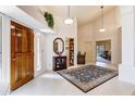 Grand entryway with high ceilings, a wood door, and a stylish rug creating a welcoming atmosphere at 25628 N Cordova Ln, Rio Verde, AZ 85263