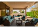 Comfortable covered patio featuring cozy seating, providing a perfect outdoor relaxation space overlooking the pool at 290 N Nash Way, Chandler, AZ 85225