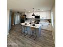 Beautifully updated kitchen with stainless steel appliances, an island with barstool seating, and stylish backsplash at 3345 E Edgewood Ave, Mesa, AZ 85204