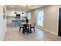Open concept kitchen with stainless steel appliances and an island with barstool seating at 3345 E Edgewood Ave, Mesa, AZ 85204