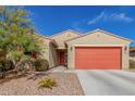 Charming single-story home with desert landscaping, a red garage door, and a matching front door at 4402 W Bush Bean Way, San Tan Valley, AZ 85144