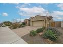 Desert landscaping adds appeal to this single Gathering house with brick paver driveway and easy access to walking paths at 4609 S 122Nd S Dr, Avondale, AZ 85323