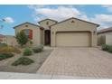 Charming single-story home featuring a brick driveway, two car garage and low maintenance desert landscaping at 4609 S 122Nd S Dr, Avondale, AZ 85323