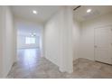 Bright hallway features neutral tile flooring and gives access to a den/office and the main living space at 4609 S 122Nd S Dr, Avondale, AZ 85323