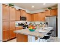 Well-equipped kitchen featuring stainless steel appliances, granite countertops, and light wood cabinetry at 4609 S 122Nd S Dr, Avondale, AZ 85323