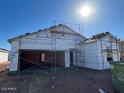 New home construction showing framing, and a garage with new roof tiles under a sunny sky at 6099 E Artemis Dr, Florence, AZ 85132