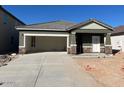 Single-story home under construction with an attached garage and concrete driveway at 6130 E Artemis Dr, Florence, AZ 85132
